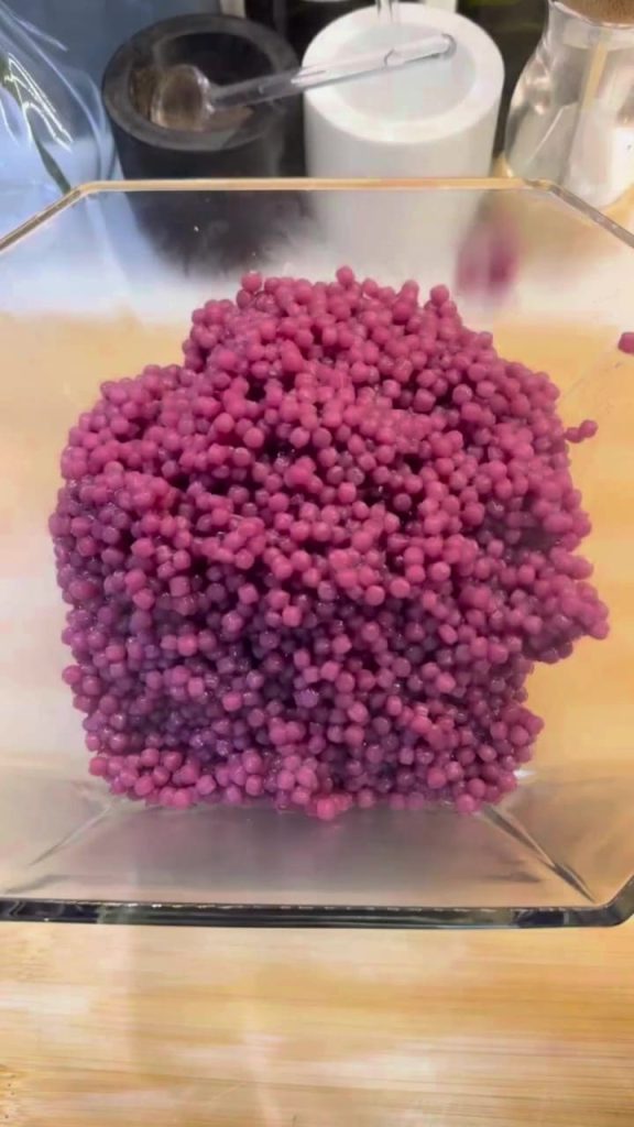 Letting the cooked purple couscous cool down in a large bowl.
