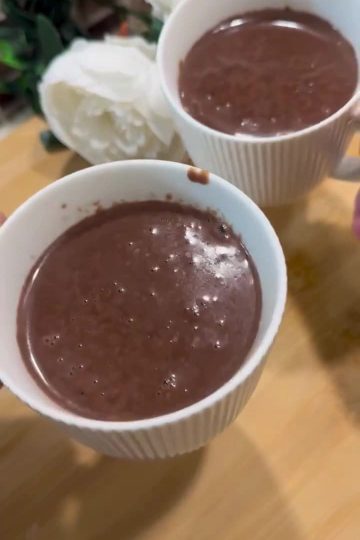 A mug of thick Turkish hot chocolate topped with foam and chocolate shavings.
