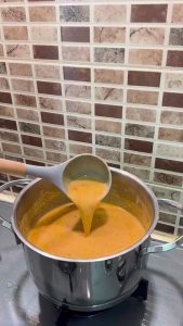 Adding salt to a finished Turkish yogurt soup.