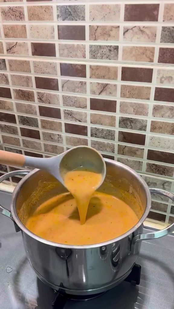 Adding salt to a finished Turkish yogurt soup.