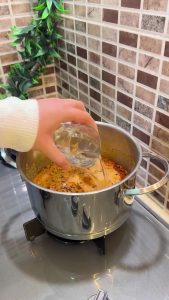Stirring a creamy yogurt soup while it comes to a boil.