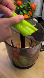 Finely dicing vegetables in a food processor for lahmacun topping.