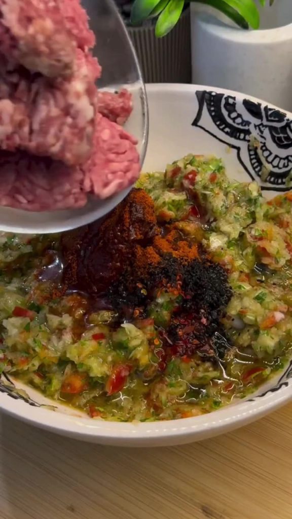 Mixing ground beef and spices for the Turkish lahmacun topping.