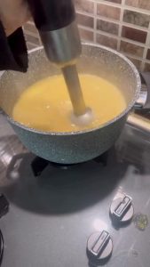 Blending a Turkish lentil soup with an immersion blender.