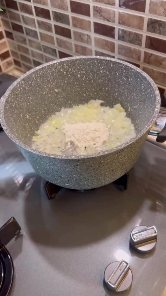 Sautéing onions and flour in a soup pot for Ottoman soup.