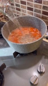 Simmering red lentils in a large pot for Çeşmi Nigar.