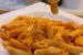 A bowl of penne pasta coated in a vibrant, creamy orange pepper paste sauce.