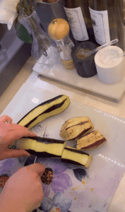 Slicing eggplants into sections for a Turkish dizme dish.
