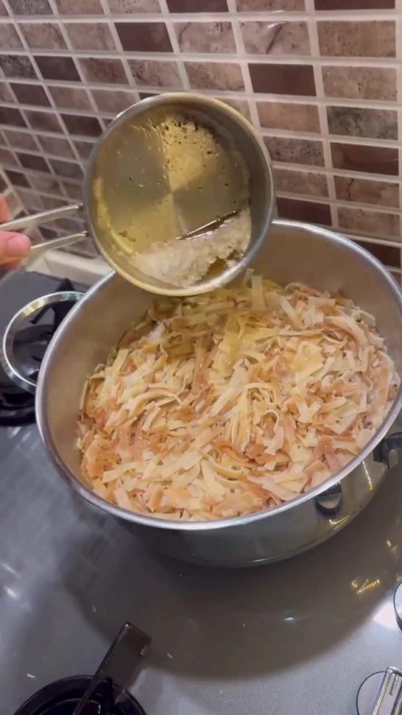 Adding browned butter and cheese to Turkish egg noodles.