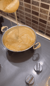 Serving a hot pan of Turkish Muhlama on a breakfast table.
