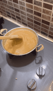 Stirring a thickening cornmeal sauce for Muhlama.