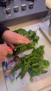 Chopping fresh spinach and onions for a Turkish meze.
