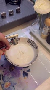 Whisking garlic and yogurt for a Turkish dip.