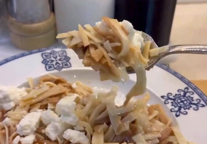 A plate of golden toasted Turkish egg noodles topped with crumbled cheese and browned butter.